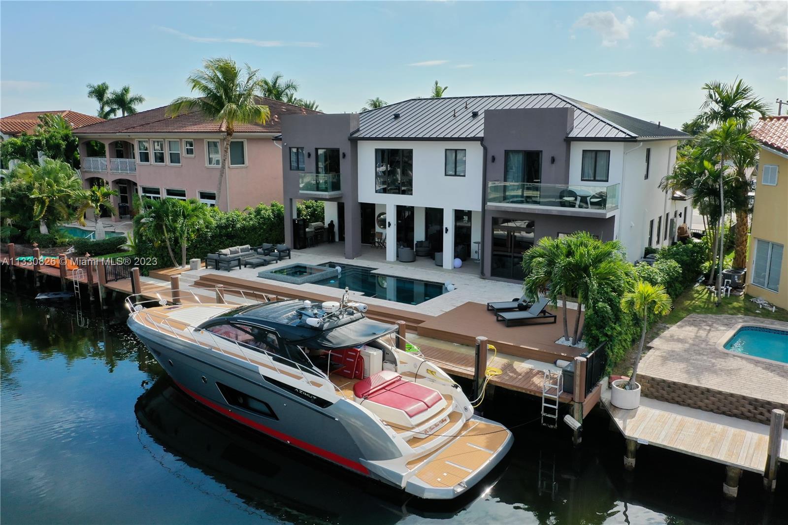 The seller is delighted to announce a PRICE IMPROVEMENT on this amazing waterfront house. Bring your boat and enjoy being a South Florida waterfront homeowner! 80ft w/ ocean access, NO FIXED BRIDGES. Absolutely spectacular 5-bed/6-bath home in Lighthouse Point. Watch the sunset from your backyard while enjoying the heated pool and spa with canal views. This home has stunning water views from almost every room. It has open spaces, large impact windows, porcelain floors, high ceilings, and a grand staircase. An elevator will take you from the spacious first story to the 4 bedrooms upstairs. 2021. 3 car garage. Minutes from the ocean, airport, Ft. Lauderdale! 2 minutes from the ICW, 20 minutes to Boca Inlet, and 12 minutes to LHP Inlet.