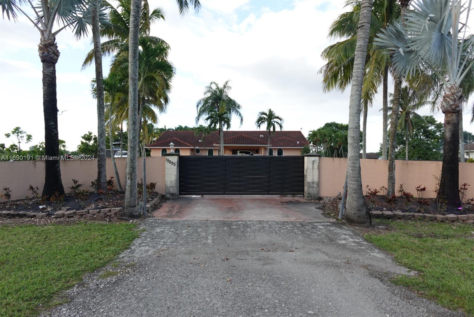 "Embrace the tranquility of Miami's Redlands with this charming ranch-style property, blending rustic appeal and thoughtful updates. Surrounded by mature mamey, avocado, and palm trees, this home offers a serene escape. Recently enhanced with a new roof, impact doors and windows, and a powerful separate generator, this property ensures peace of mind.
Unique investment potential: a private section with its own automatic gate generates $4,000/month as a storage yard. With a two-car garage and a fenced perimeter completed just three years ago, this is an idyllic retreat with income opportunities in the heart of the Redlands.