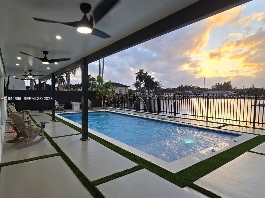 Beautifully updated 4-bedroom, 3-bath modern residence offering porcelain flooring, soaring ceilings, and an expansive open-concept kitchen with high-end finishes. Features include a two-car garage with EV charging, covered terrace, contemporary pool with LED lighting, and serene waterfront views. Move-in ready with outstanding curb appeal, located in a secure, non-HOA community. A truly exceptional opportunity.