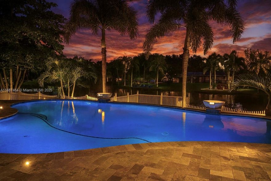 LUXURY OASIS ON A SPRAWLING BUILDERS ACRE-LAKEFRONT LOT IN DAVIE WEST! STUNNING TURNKEY 3 BEDROOM - 2 BATH + FLEX ROOM W/ROOM TO BUILD ON. RANCH STYLE HOME W/ OVERSIZED PAVED DRIVEWAY. DESIGNED FOR ULTIMATE COMFORT & UNFORGETTABLE ENTERTAINING. BACKYARD SHOWCASES TRAVERTINE AROUND SALT WATER POOL W/ SWIM UP BARSTOOLS. TIKI BAR, LARGE COVERED PATIO, FENCED YARD W/ SPACIOUS DECK ON THE LAKE, PERFECT FOR FISHING! KITCHEN HAS EXPANSIVE STORAGE, WOOD CABINETS, PASS THRU WINDOW, GRANITE COUNTERTOPS W/ LARGE ISLAND & EAT IN COUNTER, NEW FLAT ROOF W/WARRANTY, APPLIANCES & WATER HEATER. RENOVATED BATHROOMS & BEDROOM FLOORS. PRIMARY SUITE W/ WALK IN CLOSET. HURRICANE IMPACT WINDOWS & DOORS. NEW SPRINKLER SYSTEM RUNS OFF LAKE. EXCELLENT SCHOOLS. NO RESTRICTIONS-COMMUNITY IS ANIMAL, BOAT & RV FRIENDLY