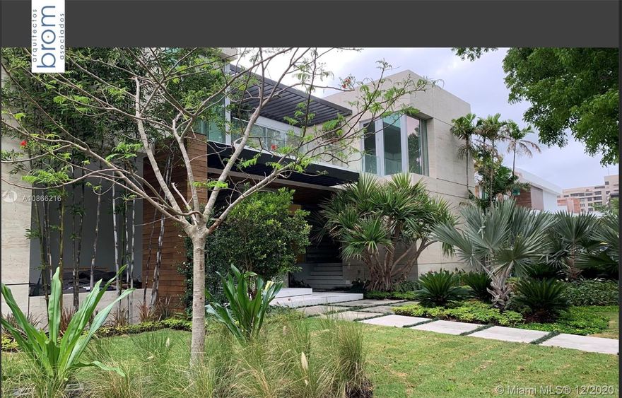 Located on a 12,500 sq. corner lot surrounded by beautiful landscape and just a few steps away from the key Biscayne beach this house blends in with the ocean.
A combination of exposed concrete, roman travertine marble, and Timura wood volumes are interconnected, true open spaces, extensive terraces, green trellises, and an impressive 60´ long lap pool, 5,500 sf. under HVAC area, and a gross area of 7,680 sf. Italian Quarella floors, beautiful Italian kitchen by Binova Cucine, Plumbing fixtures by Dornbracht, Gessi, Toto Neorest, etc. State of the art kitchen appliances, Lighting and Crestorn integrated system.