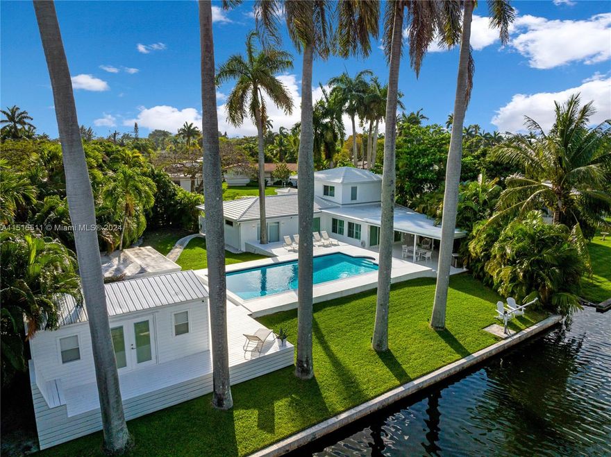 Spectacular home on stunning grounds! This special home offers 3 bedroom 2 bathroom on the main floor, an additional 2 bedroom 1 bath on the 2nd floor & 1 bedroom 1 bath pool cottage for a total of 6 bedroom, 4 bath. This home can be either used as a single family home, or as multi family as it is also zoned for it. It offers an open floor plan, with large sliding glass doors that leads out to the magnificent outdoor pool area. huge deck and a very spacious covered dining area and 110 ft of canal front.The second floor is totally independent from the main house with its own entrance, its own kitchen, AC unit, living room, plus 2 bedroom 1 bathroom. It could be either rented or used for older kids, or in-laws.  The pool cottage is air conditioned and has a full bathroom.  It is a must see!!