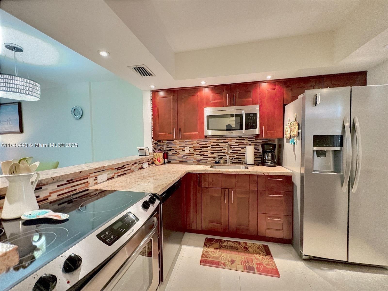 Fully Renovated 1-Bedroom Condo in Prime Hallandale Beach Location! Beautifully updated 1-bedroom, 1-bath condo in the desirable April Breeze community. Features sleek porcelain tile floors and a modern open layout with the kitchen wall removed for extra space. Enjoy your private back patio just steps from the community pool. Located under 5 minutes from the beach and right across the street from Publix and Winn-Dixie, a well-known supermarkets, shops, restaurants, and a variety of dining options on 2 Plazas. Upgrades include a tankless water heater and a new AC system for your comfort and efficiency. This move-in-ready gem won't last