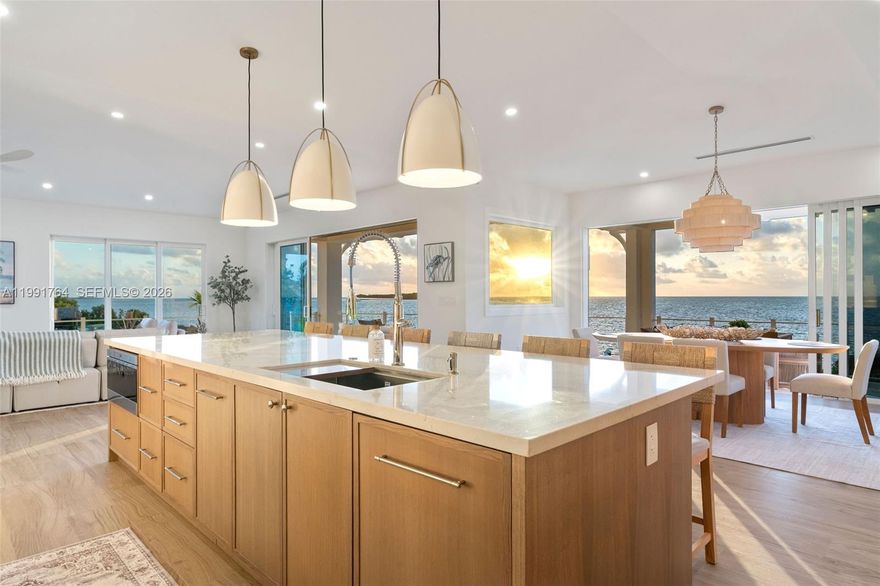 Brand-new luxury oceanfront estate in Key Largo with over 300 ft of water frontage and sweeping open-water views. Built by renowned Nivar Group, this newly completed residence offers elite craftsmanship and a private alternative to Ocean Reef living. Features include 4 spacious bedrooms with ensuite baths, a private office or optional 5th bedroom, and a guest half bath. The expansive primary suite offers custom his-and-hers walk-in closets with built-ins. Open-concept living spaces capture stunning ocean views and seamless indoor-outdoor living. Chef’s kitchen equipped with premium Sub-Zero and Wolf appliances. Outdoor amenities include a resort-style pool and spa overlooking the Atlantic. Boating enthusiasts will appreciate multiple dockage options, including a cut-in dock with 12,000 lb lift, an additional 24,000 lb lift, and a dedicated loading dock for easy ocean access. Additional highlights include a private elevator, enclosed ground level for storage or entertaining, and whole-home generator. Exceptional waterfront living in the Florida Keys.