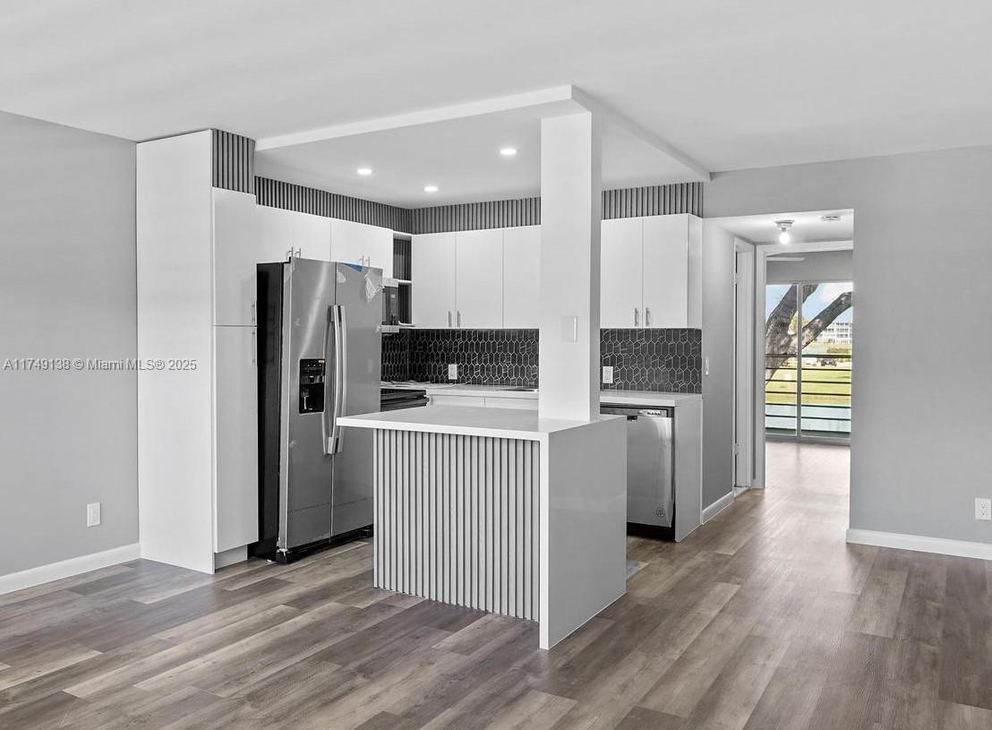 Fully remodeled second-floor condo in the highly desirable Dorset building at Century Village! No detail was overlooked in this immaculate renovation, which includes a brand-new open kitchen with a stylish island and new appliances. The entire unit has been professionally rewired, with additional recessed lighting installed in both the kitchen and bedroom ceilings—all work was completed with permits and approved by the city for your peace of mind.
The stunning new bathroom adds a luxurious touch, and all-new lighting fixtures throughout the condo elevate the living experience. Step out onto your private patio to enjoy serene lake views—without the usual worry of lizards roaming nearby! Located just a short walk from the swimming pool and centrally positioned within Century Village.