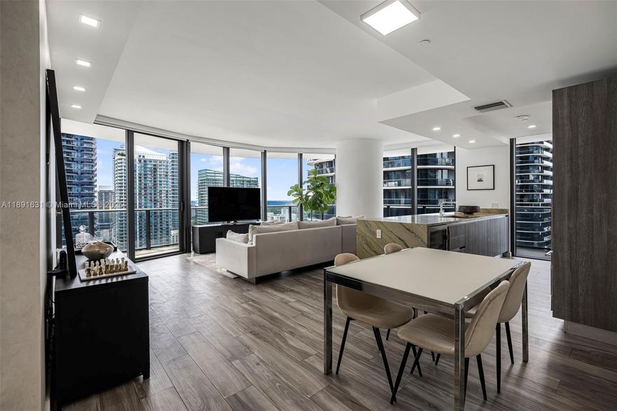 Stunning corner residence in one of Brickell’s most exclusive towers & steps from Brickell City Centre. This coveted 01 line unit features 3-bedrooms, 4-bathrooms, as well as a private elevator that opens to a dedicated foyer, floor-to-ceiling windows framing dramatic city & bay views, and a wraparound balcony connecting all rooms. This is the only unit in the SLS Lux with an expanded primary suite and a closed-off den/laundry room. Also includes rare attached storage, and 3 total parking spaces (two assigned parking spaces - no lift + one valet). Every detail exudes luxury—developer upgrades, WOLF appliances, marble counters, wine cooler, motorized blinds, smart lighting (with voice controls). Impeccably maintained by its owners, never rented—a true masterpiece for the best price.