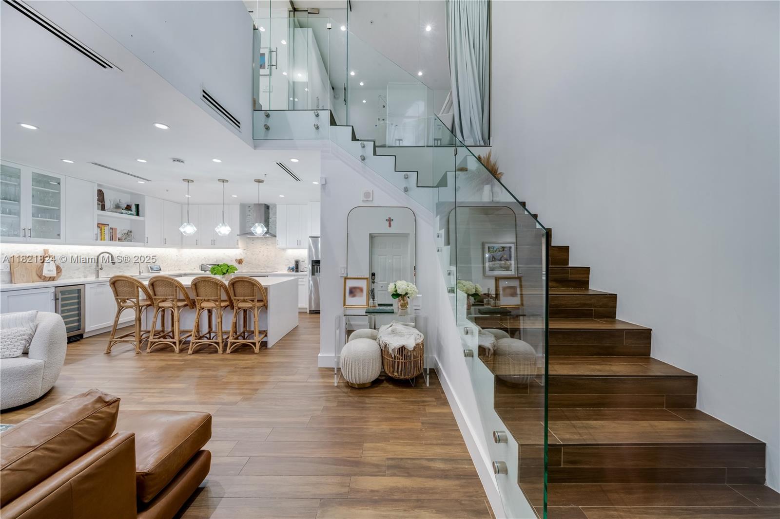 Beautifully updated townhouse in the heart of the Gables! This stylish 1-bedroom, 1.5-bath home features a modern, crisp design with sleek finishes throughout. The contemporary glass stair railing and custom glass partition upstairs enhance both light and space, offering added privacy and versatility—currently used as a charming nursery. An ideal blend of function and design, this move-in-ready gem is perfect for anyone seeking sophisticated urban living just steps from the best of Coral Gables.