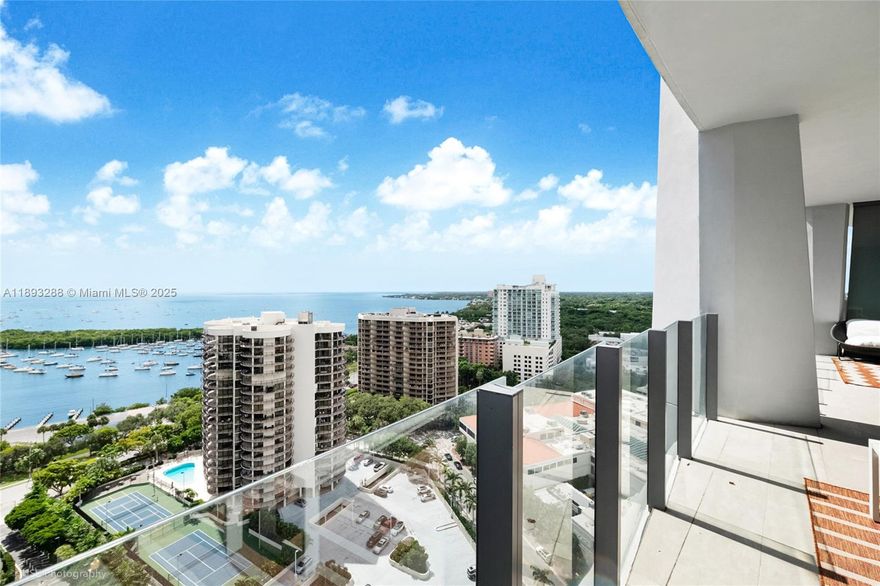 Discover luxury in this exquisite 2-bedroom, 2-bathroom apartment with a versatile den on the 21st floor of Park Grove Residences, Line #02. Soaring 10ft ceilings and floor-to-ceiling glass walls flood the space with light, showcasing stunning bay views. The expansive terrace is perfect for entertaining or relaxing. Premium finishes, sleek cabinetry, and top-tier appliances blend sophistication and comfort. Steps from Coconut Grove’s charming boutiques and vibrant cafés, this home offers Miami’s cosmopolitan lifestyle. Enjoy world-class amenities: rooftop pool, fitness center, spa, 28-seat screening room, kids’ playroom, 5 acres of lush gardens, and 24-hour concierge.