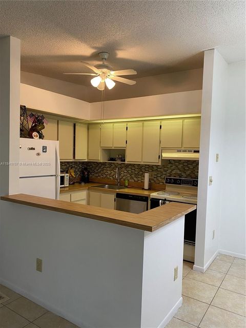 Photo of 10407 E Clairmont Cir #210, Tamarac, FL 33321 (MLS # A11840767)