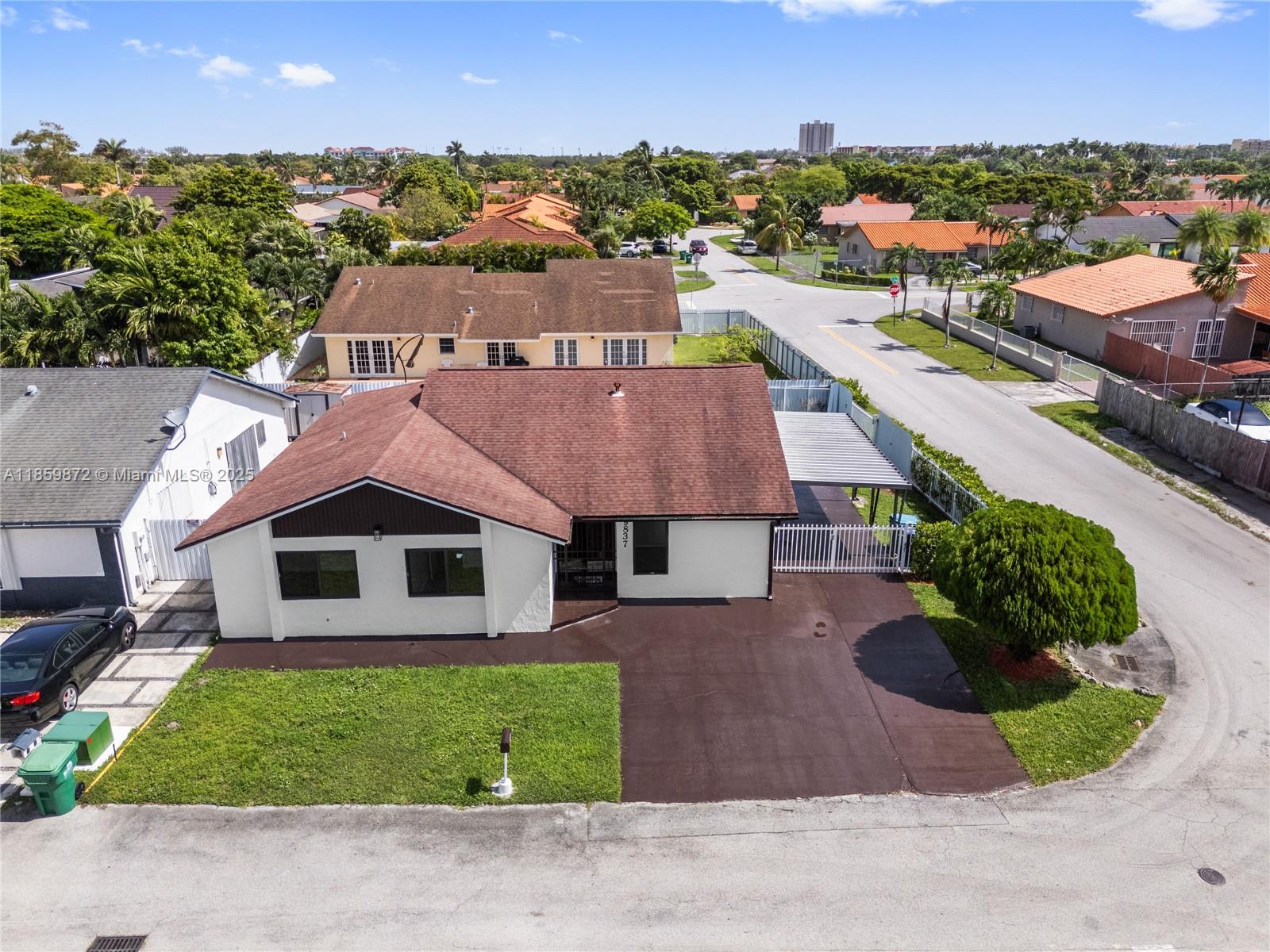 Welcome home to this charming, freshly updated 3-bedroom, 2-bath corner gem, tucked away in a central neighborhood putting all of Miami right at your fingertips. The property features one of the largest fenced corner lots in Les Chalets II, complete with an attached carport and a handy side gate ready for your boat or RV, with no HOA. Inside laminate wood floors flow through every room, giving the home a warm, cohesive feel. Recent upgrades include hurricane-proof impact windows for peace of mind, a stylish modern kitchen with stone countertops, and updated bathrooms. There is also a den, perfect for a home office or cozy reading nook.