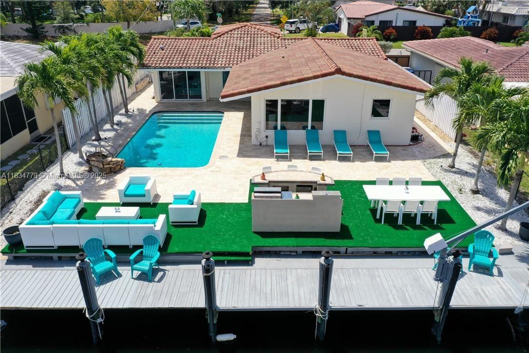 Live the ultimate South Florida lifestyle in this beautifully upgraded waterfront home located in highly desirable Pompano Isles. This 3 bed, 2 bath offers the perfect blend of luxury and comfort with large windows that fill the home with natural light and water views. Enjoy UNRESTRCTED OCEAN ACCESS with 50 ft private dock. Entertain effortlessly with a stunning outdoor kitchen, sparkling pool, and travertine pavers. The circular driveway provides plenty of parking. Step inside to elegant marble floors, an updated kitchen with modern finishes, and a finished garage featuring an additional half bath, perfect as a guest suite, gym, or flex space. Whether you’re looking for your forever home or a luxurious retreat, this move-in ready gem delivers waterfront living at its finest.