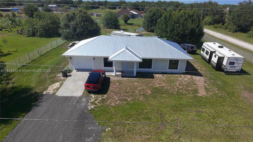 Single family home COMPLETELY REMODELED!!  NEW 2025 Metal Roof - Windows- Fence all around property. The home features three bedrooms, two bathrooms, and the garage can be converted to an additional guest room. New appliances, renovated baths and Kitchen with quartz countertop !!!Don't miss out on this unique property!!!This peaceful community offers a quiet, rural feel while still being centrally located. This is a fantastic opportunity to own a beautiful home on 1.25 acres with a beautiful pond in Montura Ranch Estates, free from any association fees or restrictions. Located just one hour from Miami, this property offers a tranquil escape from the city's traffic, allowing you to enjoy the peace of a country community. PRICE REDUCED – MOTIVATED SELLER!
