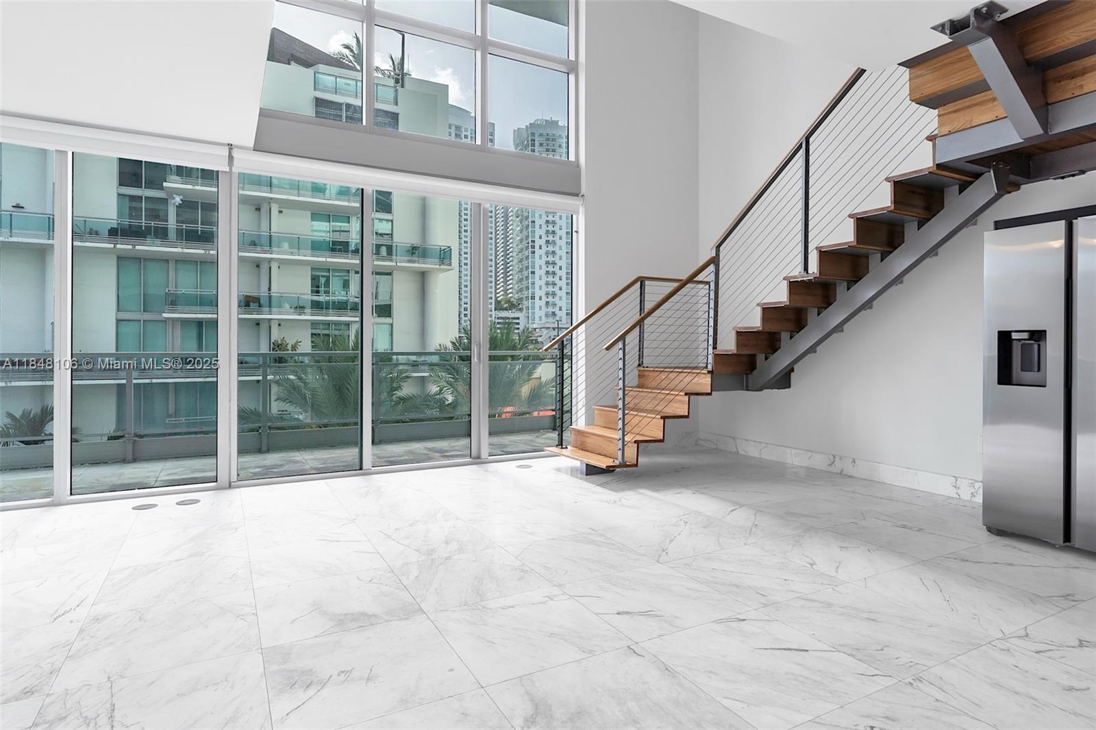 Rare 2-Story Loft Townhome at The Ivy! Located in a private, gated riverfront community just steps from Brickell - without the chaos. One of only 8 townhomes in the building, this bright and airy residence features soaring double-height windows and marble flooring throughout. The open loft layout includes a den with closet, perfect as a home office or guest room. Brand-new refrigerator and washer/dryer. The Ivy is a well-managed building with strong reserves, no assessments, and easy financing. Enjoy full amenities and riverfront living in the heart of the city.