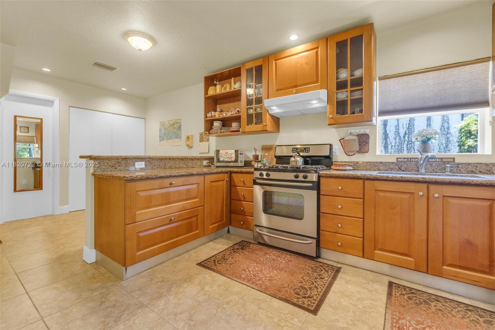 Generously sized bedrooms, 3 good sized closets + one extra large closet, Extra Large linen closet. Extra room off dining area & includes a pantry W/ extra storage. Large kitchen includes stainless steel sink, gas range/oven, breakfast bar & custom hardwood cabinetry & granite counter tops. Original wide-plank red oak wood floors. Extra space off the kitchen can be used as a breakfast nook/office area. Noritz tankless gas HWH , natural gas Generac Guardian generator, Flow-Tek ground water pump sprinkler system & Lark 10x20 foot raised storage shed/workshop rated secure for winds up to 150 mph with 4 windows, wide doorway & electricity. The beautiful back yard invites outdoor living W/ patio, deck & covered back porch. Located minutes from downtown Hollywood & Hollywood Beach & Broadwalk