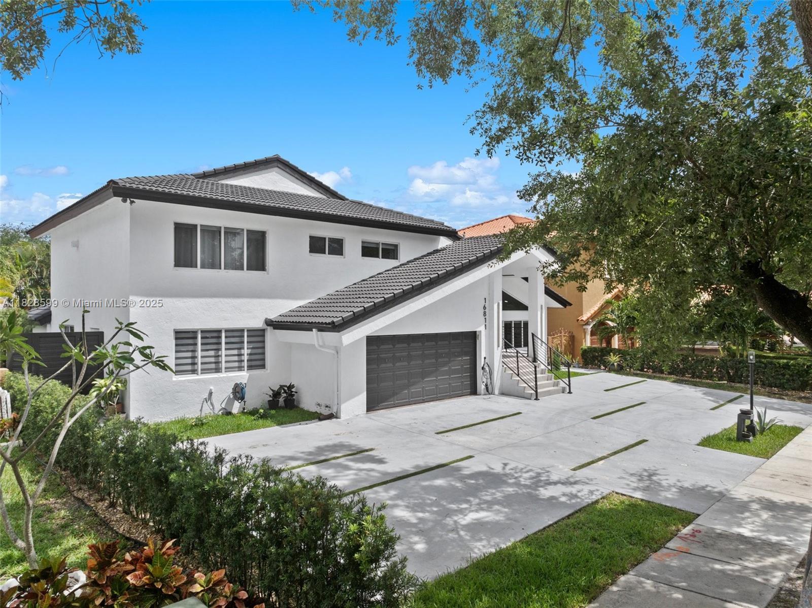 Discover this tastefully remodeled residence in the prestigious Royal Oaks community of Miami Lakes, An extended driveway leads to a modern entrance, welcoming you into a home where contemporary style meets comfort. Enjoy a beautifully updated kitchen boasting sleek countertops, state-of-the-art appliances, and ample cabinetry perfect for culinary enthusiasts and entertaining alike. The master bathroom has been redesigned into a spa-like retreat with elegant finishes. The outdoor patio area has also been transformed, providing an ideal setting for relaxation and gatherings. Located near top-rated schools, shopping, dining, and major highways, this home blends modern luxury with everyday convenience. Experience the perfect blend of modern luxury and convenience in this remarkable home.