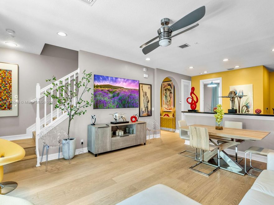 Spacious 3BD/3BA + den/office townhome in desirable Belle Isle, Wilton Manors.  This bright 3-story 1,945 sf unit features engineered hardwood floors, impact windows & doors, & a flexible 1st-floor space- perfect for an office, den, or extra bedroom.  Open 2nd floor includes living & dining areas, modern kitchen w LG stainless steel appliances and a balcony overlooking pool and garden - perfect for evening relaxation.  Primary bedroom offers walk-in custom closet & en-suite bath. 2 car garage with a  generator transfer switch, custom storage racks + ample guest parking.  Community features heated pool, lush landscaping, underground utilities & pet-friendly policies.  HOA includes ADT security & smoke detection, & strong reserves.  Steps to Wilton Drive - walk to shop, dining, & nightlife.