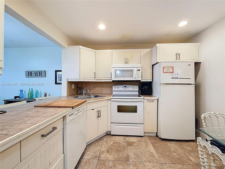 Great location across from Gulfstream Horse Racing and Casino. less then 10 minutes to Aventura Mall. close to restaurants, shopping, banks and the beach.  This is a comer unit, first floor, with a walk out balcony to the garden area. Impact glass throughout. Completely tiled. Eat in kitchen with a window. All assessments paid by seller. Building has passed Milestone inspection and is in great shape. This is a wonderful opportunity to live in an affordable complex with reasonable maintenance payments, and all the infrastructure work is completed.