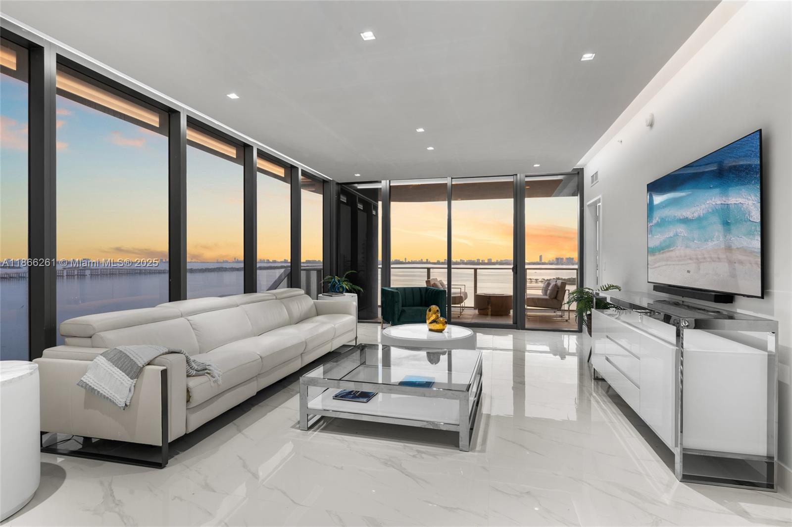 Turnkey and move-in ready, this fully furnished residence with $100K+ in designer upgrades is perfectly positioned on the 12 floor, high enough for sweeping panoramas yet low enough to feel right on the water. Enjoy unobstructed bay, ocean, and skyline views that flow seamlessly from sunrise to sunset in this 4-bedroom + den, 5.5 bath home with maid’s quarters. Custom closets, blinds, and dual private elevator entry add to the elevated living experience. Floor-to-ceiling windows bathe each room in natural light, while spa-style en-suites create a retreat for every bedroom. Aria Reserve, Miami’s largest waterfront residential site, offers 2 acres of resort-style amenities including 3 pools, spa, fitness center, tennis, paddleball, basketball, theater, dog park, kid’s splash pad, and more.