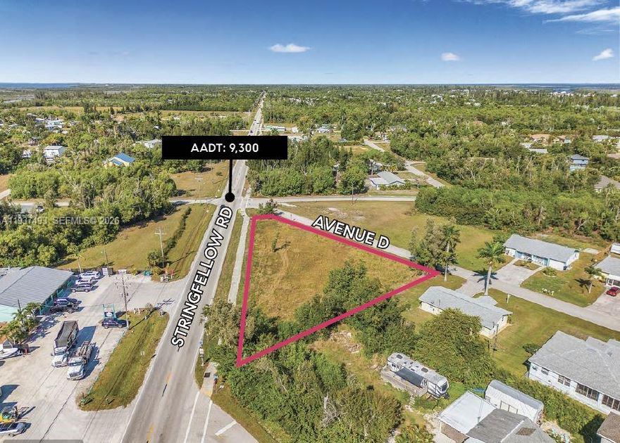 Introducing a prime commercial development opportunity on Pine Island — 5585 Avenue D, Bokeelia, FL 33922. This 0.6052-acre (26,363 SF) parcel offers C-1 zoning and a VAC COMM (1000) land-use designation, making it suitable for a wide array of commercial uses including retail, medical, office, service businesses, and more. The property sits along Avenue D, which benefits approximately 9,300 vehicles per day, ensuring strong visibility and easy access for future customers. This traffic volume is rare for local island roads and provides a solid foundation for commercial viability. Only 1.5–2 miles away is the Publix Super Market at Calusa Cay, the retail anchor for the Pine Island community. The center includes additional national and regional tenants, reinforcing the strength of the corridor and signaling healthy consumer demand. Nearby operators include Publix, CVS, Dollar General, Subway, and other established chains that support daily island traffic. As Pine Island and Bokeelia continue to grow, demand for new commercial services is rapidly increasing. Whether for an investor seeking a strategic land hold or a developer looking to build a new retail or medical project, this parcel offers exceptional potential in one of Southwest Florida’s most unique and evolving market