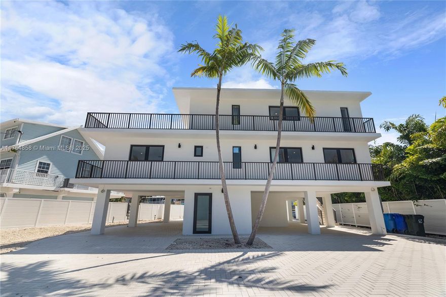 Waterfront, modern, luxury home in the Florida Keys with unobstructed ocean access minutes to reefs, fishing & diving! Impact casement windows & doors, new central A/C's, plus solid CBS construction. Concrete dock has water & electricity. Enjoy an inviting & heated pool, covered BBQ area with refrigerator, icemaker, and concrete counters. Half bathroom & laundry room also on ground floor. Main level encompasses an elegant kitchen with high-end appliances, living & dining areas plus two bedrooms & two full baths. Great for entertainment indoor & outdoor. The third level is dedicated to the main suite with walk-in closet & huge sundeck. There are covered patios/sundecks on all three levels. This home sits on a large, fenced & gated lot with ample parking for multiple cars, trailers, & RV's.
