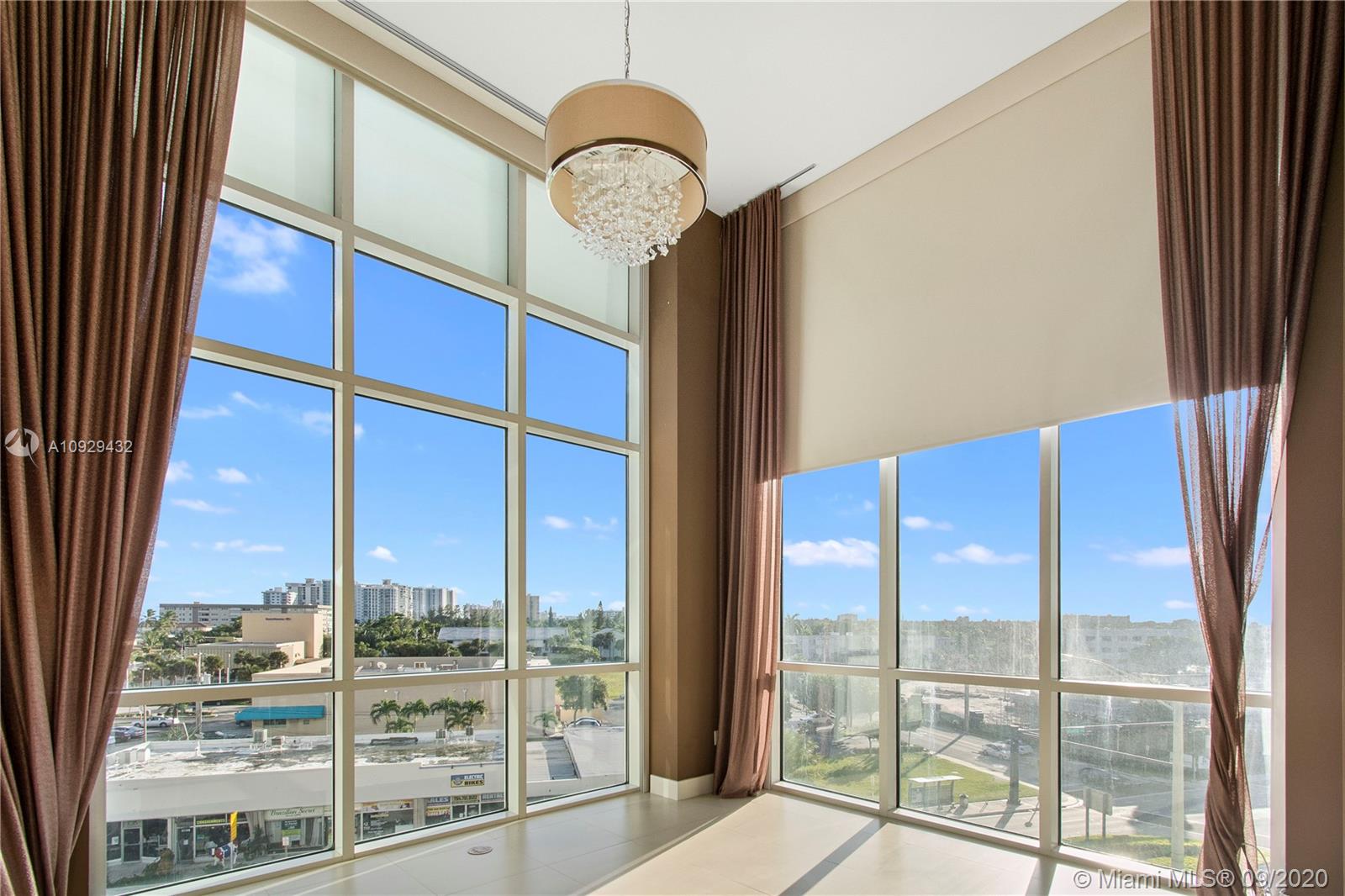 As you enter this 2BR, 2 BA luxury condo, you are taken aback by the magnitude of those 15 ft. ceilings. The West facing part of the condo enjoys copious amounts of daylight in the afternoon and a beautiful view of the sunsets. Motorized shades help you adjust the level of brightness that enters the condo. With small views of the ocean and the Intracoastal, you sense the closeness to the water. This unit is quite unique as it is on the same floor as the building's pool, so instead of having a small balcony, it enjoys its own private patio area, which is adjacent to the pool. This unit also sits on the same floor as all of the building's amenities (movie theater, library, ocean-facing gym, and breakfast area) so everything is within walking distance without having to wait for an elevator.