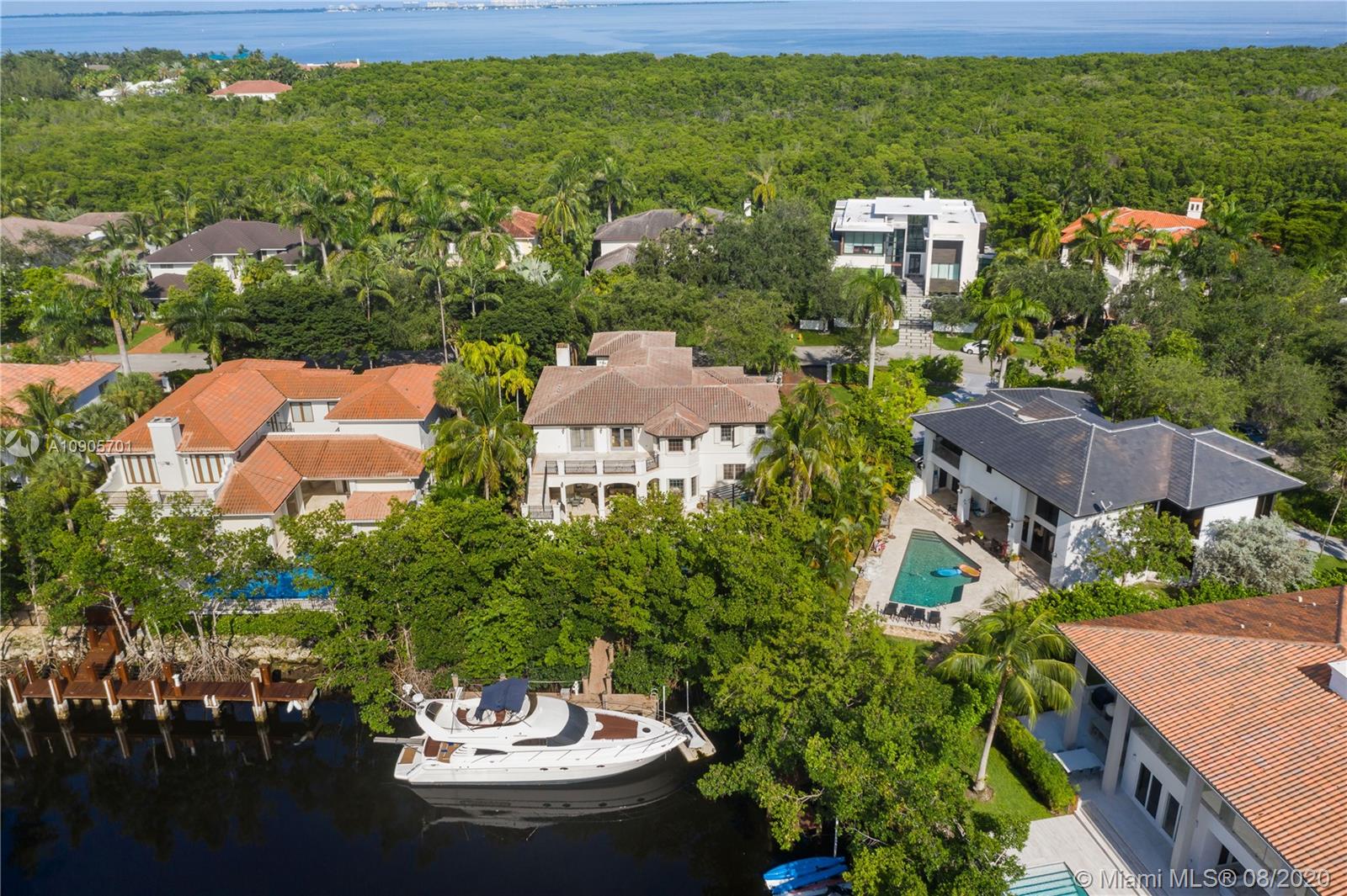 Mediterranean, timeless two-story waterfront in one of Miami’s most prestigious neighborhoods. Fits a 60ft yacht,1 bridge to bay, boating double height ceilings, elegant LVG rm & floating staircase, warm finishes from marble, travertine & mahogany finishes throughout; all bedrooms are en-suites, all 7.5 baths are tastefully remodeled, space to add an elevator, chef’s kitchen, grand family room opens up to the covered terrace, pristine pool & spa surrounded by lush foliage making an excellent space for private entertainment w/ a tropical pathway to your boat! 2nd floor has 4 suites including the grand master suite w/ expansive terrace & staircase to the pool; 3 car garage & maid’s quarters! Cocoplum is a gated 24hr security enclave offering a clubhouse, t-courts, gym, B-ball & a playground!