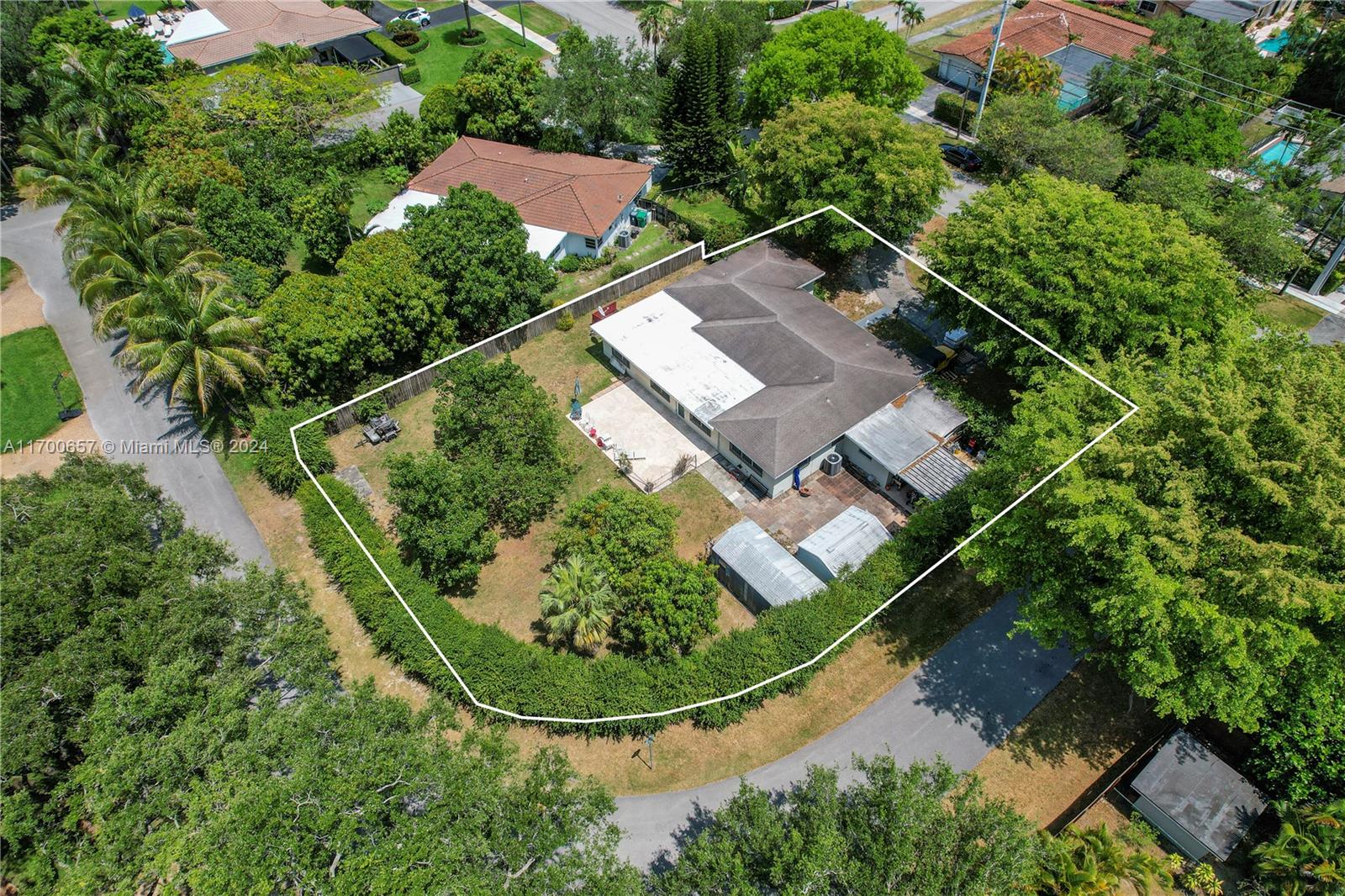 South Miami Opportunity – Remodel or Build New! Located near the University of Miami and adjacent to Coral Gables, this 4 beds/2 baths home sits on an oversized corner lot of 15,500 sq ft. The spacious yard features fruit trees and offers ample space for a pool or expansion. Impact windows provide security and energy efficiency, while the large driveway accommodates up to 5 cars. Enjoy the convenience of nearby schools, shopping, dining, and parks, all while relishing the serenity of this expansive property. This rare gem combines privacy with endless potential, making it an ideal canvas to remodel or build your dream home. Don't miss the chance to create your perfect haven in one of South Miami's most desirable locations! (Close to the University of Miami)