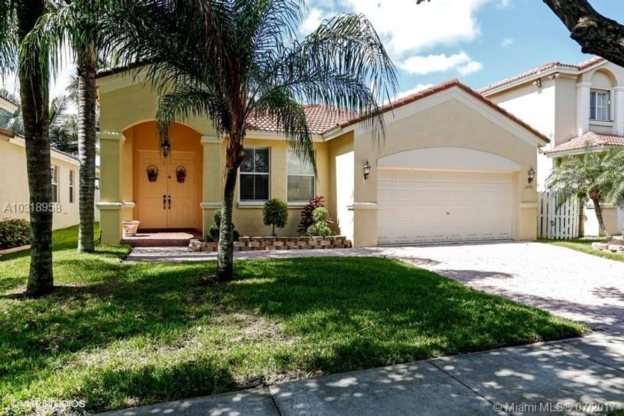 Warm and inviting LAKE-FRONT, (fenced), spacious home in great community of Monarch Lakes! This checks all the boxes: beautiful kitchen, light and bright with granite counters, stainless appliances, dining area, living room, family room, 2-car garage with storage, hurricane shutters, separate laundry room, new washer/dryer, all on serene & tranquil wide lake view. Views of lake from almost every room, plus fenced yard, covered paved patio, and also nice grassy yard. Tastefully done, neutral colors throughout, all the right touches. Community is just off Monarch Lakes Blvd, so no long line to get in. Pool is steps from the property.  Move right in and WELCOME HOME! (DINING RM CHANDELIER DOES NOT CONVEY.)