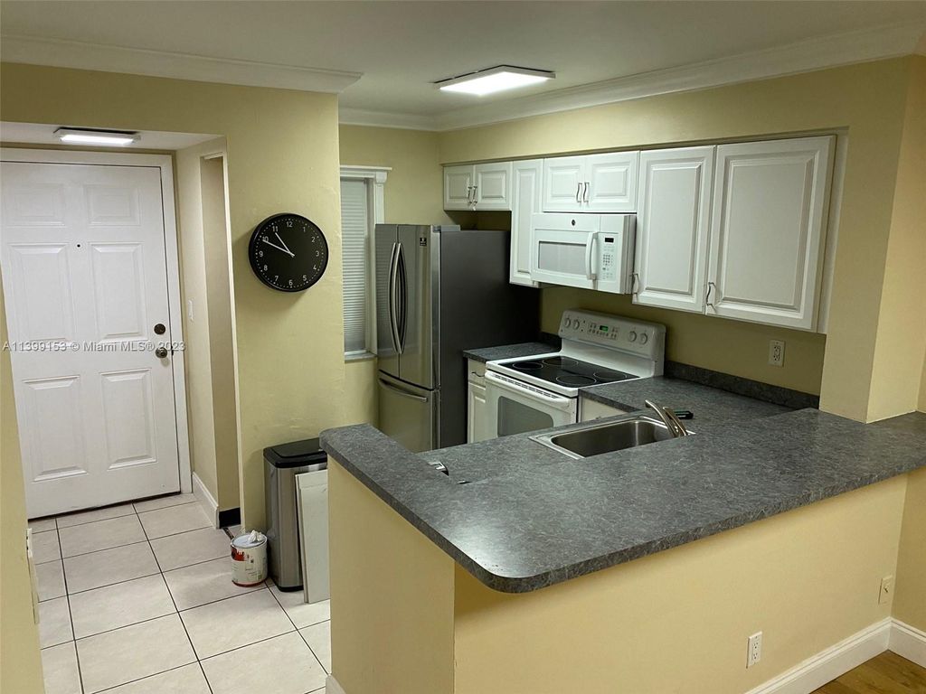 Photo of 2104 S Cypress Bend Dr #209, Pompano Beach, FL 33069 (MLS # A11399153)