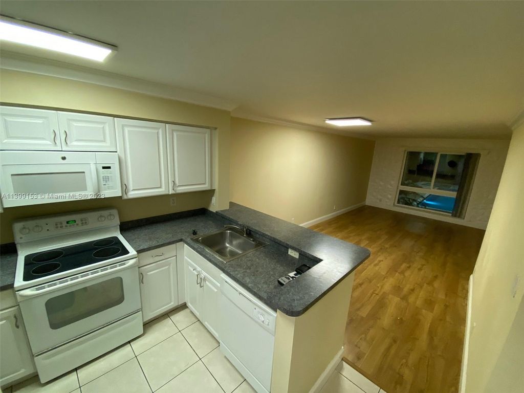 Photo of 2104 S Cypress Bend Dr #209, Pompano Beach, FL 33069 (MLS # A11399153)