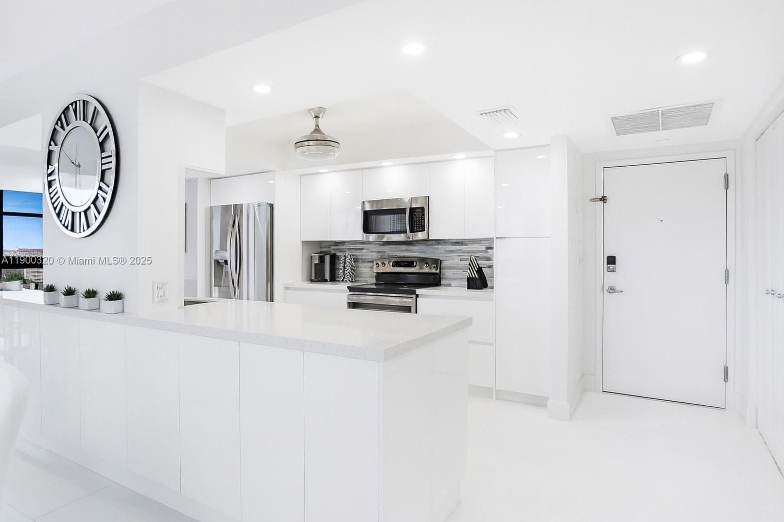 MODERN COASTAL LUXURY WITH OCEAN & INTERCOASTAL VIEWS! Fully renovated 2BD/2BA + DEN corner residence. Featuring a wrap-around balcony and direct beach access, this 1,360 SF home offers stunning ocean, intercoastal, and sunset views floor-to-ceiling hurricane-impact windows. The kitchen showcases quartz countertops, island, and custom cabinetry, opening to spacious living and dining areas. Porcelain floors, custom closets, and high-end finishes throughout create a serene coastal retreat. Resort-style amenities: 24-hour security, tennis courts, heated pool, fitness center, billiard room, and renovated lobby. The building has completed its 50-year certification, freshly painted, and has no special assessments. Lowest association on the ocean only 830. NO special assessments.