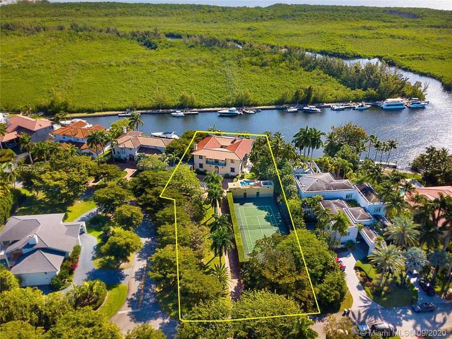 Custom-built waterfront home ideally located in the guard gated community of Hammock Oaks. Situated on a 40,000-SF lot with gorgeous views of protected Matheson Hammock, & only 1 bridge to the bay. Beautifully designed with grand spaces, 12’ ceilings, living room with fireplace, dining room, eat-in kitchen, romantic courtyard, & great room running the entire back of the house facing the water views. This majestic estate offers 6 spacious bedrooms, & 5.5-baths, including a guest bed downstairs, 4 bedrooms upstairs, & generous master suite with water views, sitting room with fireplace, private balcony, large walk-in closet, & bonus gym off master that can be turned into 7th bedroom. Outside, 36’ dock, tennis court, pool, cabana bath, covered terrace, long private driveway & 2-car garage.
