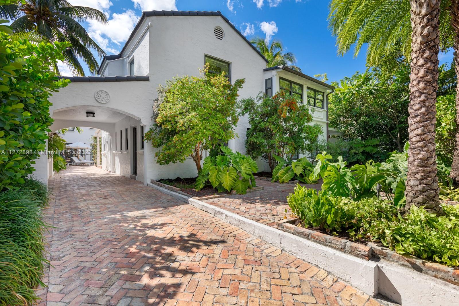 Private and peaceful estate living on Pine Tree Drive. This renovated charming and modernized Spanish revival boasts over 3,500SF of interiors including a 2 story guest house. Large entry foyer with Italian porcelain tiles throughout the first floor, large eat-in kitchen with Viking appliances and dining room looking out to a tropical patio with swimming pool. Elegant staircase leading upstairs which features 4 bedrooms and laundry room with natural hardwood flooring. Separate Guest House with downstairs cabana room, full bathroom and wet bar, perfect for entertaining. Second floor features a full suite with bedroom, bathroom, living and kitchenette. Perfectly situated minutes from the beach, shops and places of worship.