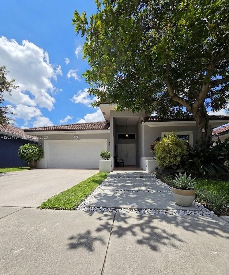 NO HOA + ROOF JUST 5 YEARS OLD — this fully renovated Hollywood home is the rare turnkey that doesn't come with monthly dues, deed restrictions, or rental caps. The barrel-tile roof was permitted and replaced in 2021, giving buyers a strong insurability profile and years of worry-free ownership ahead.

Inside, soaring vaulted cathedral ceilings run from the entry through the great room into a chef's kitchen featuring a quartz island, two-tone gloss cabinetry, copper pendants, and a full stainless package with double-oven range and hood. Wood-look tile flows throughout. The spa-style primary bath offers dual vessel sinks and a walk-in shower. 

The garage has been converted into a finished, air-conditioned home office / flex room — ideal for remote work, a studio, or a fourth sleeping space.

Major systems are new-generation: Goodman 14 SEER A/C and matched air handler (both 2021), plus a brand-new Titan N-160 tankless water heater installed in 2026 for endless hot water. Bosch SilencePlus dishwasher, Samsung counter-depth French-door refrigerator, and Sharp microwave drawer complete the kitchen.

Step outside to a private, fully fenced backyard built for South Florida living — Jacuzzi-brand spa on a cedar deck, covered pergola with string lighting, paver patio, and mature palms framing an open lawn.

Quick access to I-95, Florida's Turnpike, FLL, the beach, and Aventura. Show and sell — no HOA, new roof. Easy to show