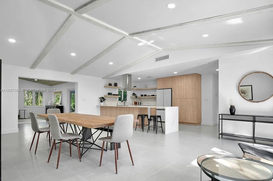 Best Price Per Foot! Just 5 blocks from Wilton Drive, this turnkey, fully remodeled 4 bed, 3 bath home is larger than the tax roll and sits on an oversized lot along a private road just a 4 minute walk to Wilton Drive!. Vaulted ceilings and expansive impact windows fill every room with natural light and garden views. The designer kitchen features custom European cabinetry, waterfall quartz counters, and new appliances—perfect for entertaining. The primary suite overlooks a brand-new pool and lush tropical gardens. Flexible layout allows two primary suites, guest rooms, office, or gym. Every detail redone with permits—roof, electrical, plumbing, baths, AC, and more. Enjoy modern style with effortless access to beaches, dining, nightlife, and the best of Wilton Manors living.