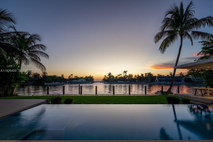 Tropical modern masterpiece on exclusive Allison Island, designed by acclaimed architecture & design firm Choeff Levy Fischman. The impressive residence spans 10,632 SF of interior space featuring 7 bedrooms, 9 full baths, and 2 half baths, a media room, wine cellar, and multiple living areas ideal for entertaining.

The expansive primary suite includes dual spa-inspired baths, walk-in closets, a sitting area, floor-to-ceiling windows, and a private terrace offering stunning sunset views. Additional features include dramatic 22-foot ceilings, two family rooms, and a junior suite with a private terrace.

The chef’s kitchen showcases custom Italian cabinetry with Sub-Zero and Wolf appliances, along with a separate staff/service kitchen and quarters. Situated on a 23,760 SF lot with 110 feet of water frontage, the home enjoys direct waterfront access and exceptional privacy.

Allison Island offers one of Miami Beach’s most exclusive guard-gated communities, providing 24-hour security within an intimate luxury enclave.