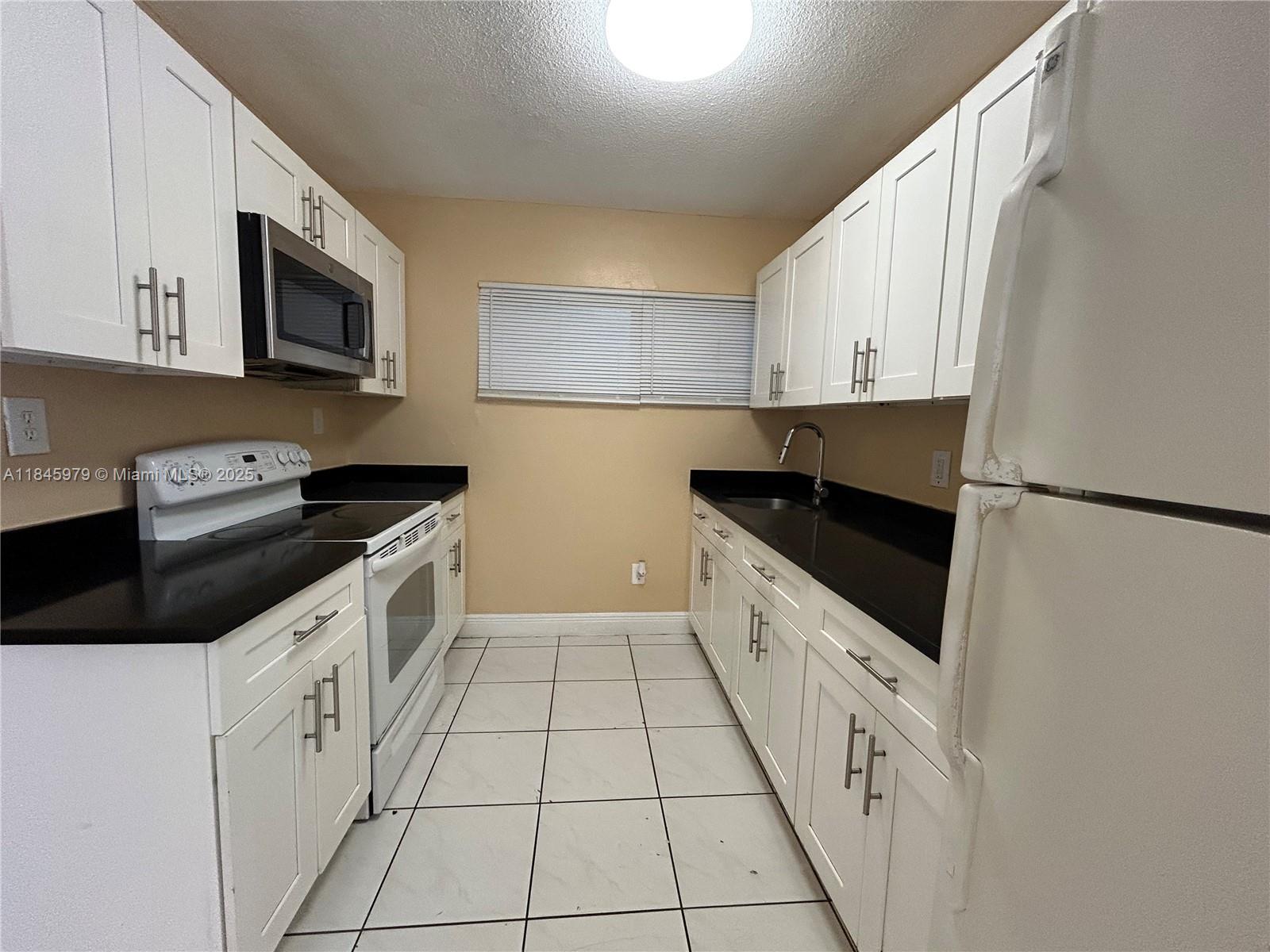 Spacious 3 bedrooms, 1 bathroom apartment in a nice multi-family building with laundry room for your convenience. This unit features updated kitchen with new cabinets and granite counters, updated bathroom, and all tile floors! Nice master bedroom, freshly painted! Water/sewer included. No pets allowed, per owner! Total of 3 months of rent required to move in - first month, last month rent, plus 1 security deposit. No HOA, fast approval.