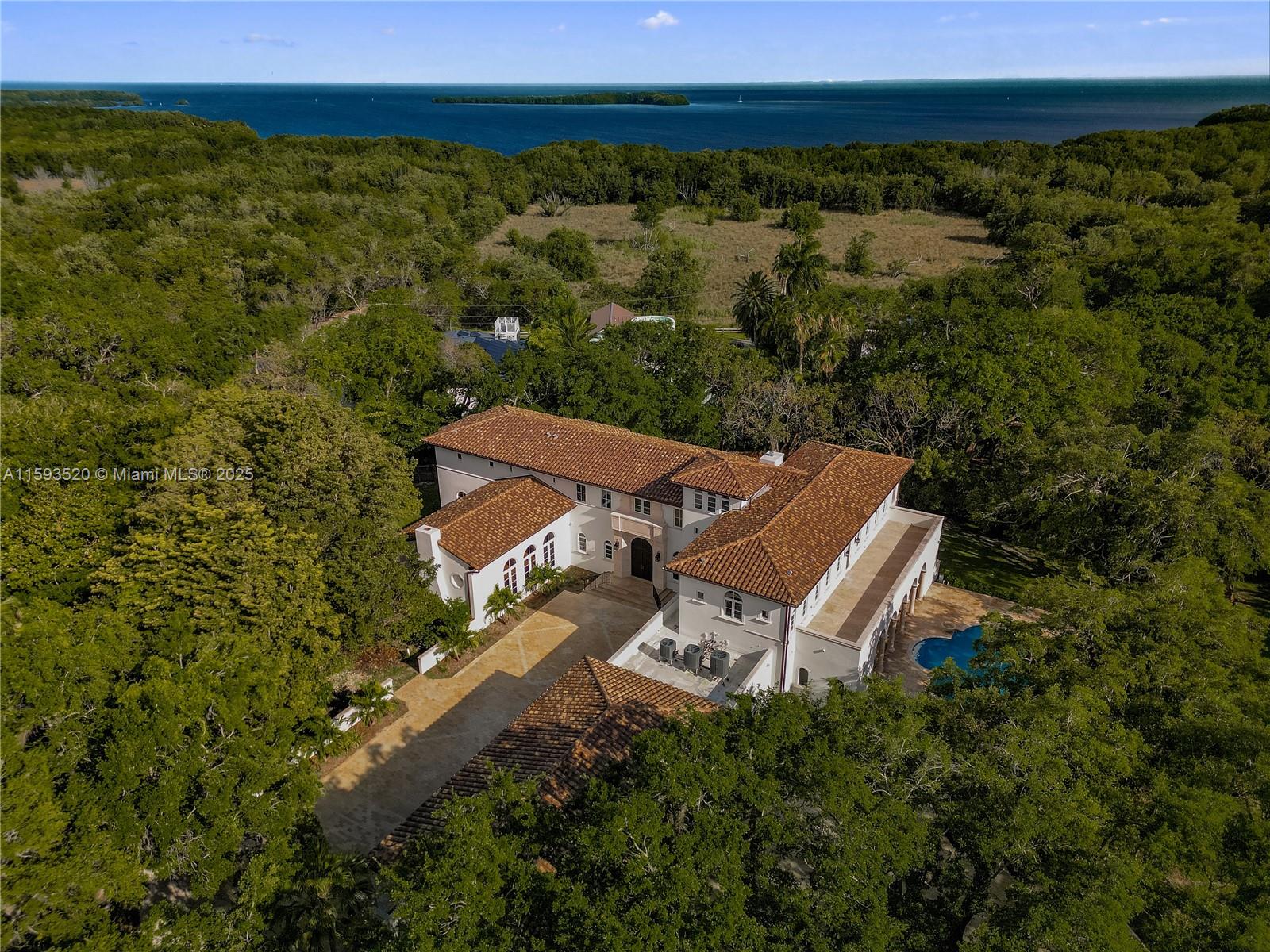 Discover Villa Palma Real, a Mediterranean masterpiece by architect Ramon Pacheco. This 11,874 SqFt estate located South of pinecrest sits on almost 2 AC lot boasting 7 beds, 7.5 baths. This gated estate is a haven for car collectors with a 12-car garage building. Be greeted by mature oak trees and lush greenery reminiscent of the nearby Biscayne Park. Inside find a recently updated kitchen with butler’s pantry. Majestic stairs, vaulted ceilings, beautiful chandeliers, luxurious travertine and wood floors. Entertain in the formal living room or relax in the master bedroom, with a separate living room, fireplace, double walking closets and spa-like bath. Additional includes a guest room, and office with views. Close to Gulliver Prep, Alexander Montessori, & Westminster Christian School.