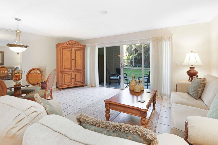 Desirable ground-floor corner unit offers 2 bedrooms and 2 baths and features parking directly in front, one assigned space plus guest parking, and beautiful pool and garden views.

Inside, a welcoming foyer with a double-door closet opens to a spacious living and dining area filled with natural light. Sliding doors lead to a screened patio accessible from both the living room and the primary bedroom, with direct access to the garden and pool—perfect for enjoying South Florida’s indoor-outdoor living.

The kitchen offers wood cabinetry, recessed lighting, a pantry, and a full appliance package including dishwasher, stove, microwave, refrigerator, and garbage disposal. An eat-in kitchen area and a second private entrance add everyday convenience. 

Both bedrooms are generously sized with ceiling fans and extra windows. The oversized primary suite includes a sitting area, a walk-in closet plus an additional double closet, and a pristine en-suite bath with a porcelain-tiled walk-in shower. The second bath features a tub/shower combination with glass enclosure. Window treatments and ample storage, including a linen closet, complete the space.

Located in a well-maintained 55+ community, this home offers easy living in a prime location close to the beach, shopping, and dining.