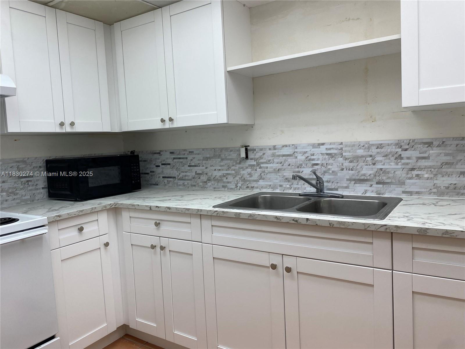 Beautiful 2-bedroom, 2-bath condo located in the desirable Samari Lakes community. This spacious unit features a large master bedroom with serene park views, generously sized second bedroom, and two full bathrooms. Enjoy NEW KITCHEN and tile flooring throughout, central A/C, and newly installed impact windows and sliding doors. Brand new kitchen cabinets and countertop allowing ample space for your family. Includes an in-unit washer and dryer for added convenience. Gated community with security guard. Very convenient location near major highways (Palmetto Expressway, and I-75), high rated schools (Mater Academy Charter Middle/High School ranked #33 in Florida), Westland Mall, BJ's and Walmart around the corner. Ready to move in. Easy to Show!