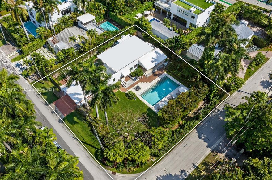 Fabulous, MiMo style home situated on a double-platted lot on lush Venetian Islands. This corner property is a true tropical oasis secluded with royal palm trees and flourishing vegetation so you can enjoy a luxury lifestyle in privacy, in one of the most exclusive neighborhoods in Miami Beach. The 4-bedroom 4-bath home is filled with natural sunlight and features impact glass windows, interconnected living areas, beautiful living room with fireplace, wood floors, updated baths, and more. Step outside the sprawling backyard to find an oversized pool with lounge areas, covered porch for outdoor dining, barbeque, and a huge green playground. DEVELOPERS can build 2 homes on the 2 lots, each with 7,200-SF of land, which is the lowest priced land/home/teardown per lot on Venetian Islands.