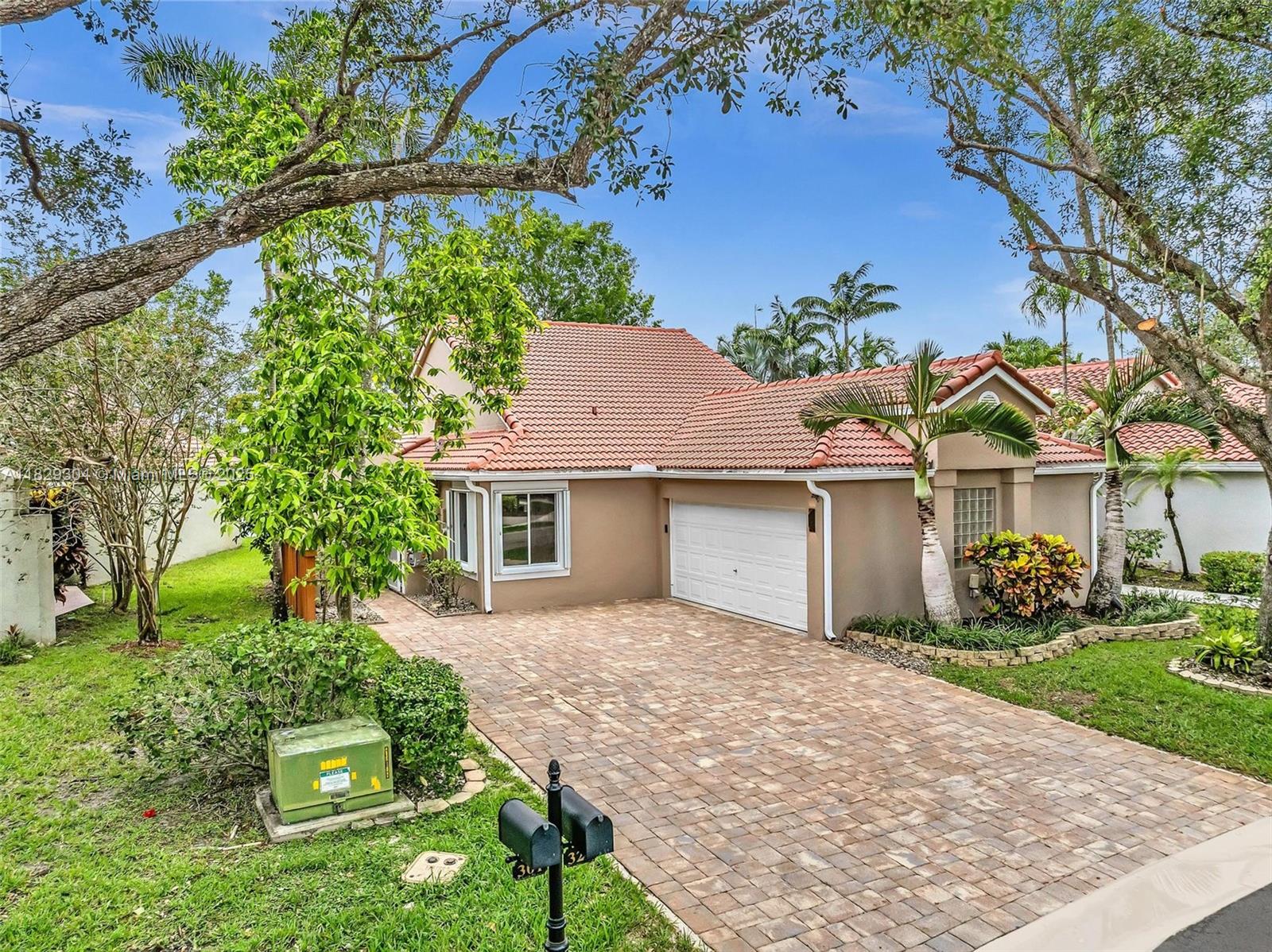 Stunning Lakefront Modern Retreat!!- Discover this exquisite single story 3/2 split bed floorplan w/2 car garage located in Sunset Cove- a prestigious gated comm. w/24/7 manned Security. Perfectly positioned on the coveted Central Park lake w/breathtaking, water views ideal for discerning buyers seeking elegance & tranquility. Inside, experience a bright, airy ambiance, w/soaring high ceilings & abundant natural lighting streaming thru expansive windows. Every detail of this home exudes sophistication. Features all new porcelain tile, new AC, new copper pipes, full house water filtration system, solar hot water, accordion shutters, freshly painted, brick paver hardscaping & exotic plants & much more. Prime location, water views & many upgrades make it a rare gem! Schedule your appt today!!