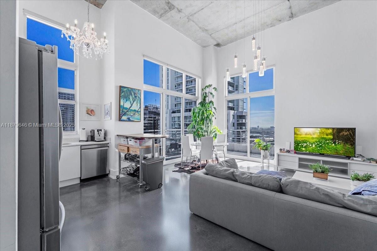 Rarely available Upper Penthouse with soaring 16ft ceilings and sweeping bay & city views! This corner loft-style residence is bathed in natural light from floor-to-ceiling glass. The floor plan includes one enclosed bedroom plus a second open loft bedroom connected to the kitchen and living area, easily convertible into a true second bedroom. Amenities include two pools (one just steps from your door and another at ground level), a rooftop gym with sauna, and an elegant clubroom. Walk to the Arena, Bayside, museums, and Brickell, with South Beach only minutes away. A rare penthouse opportunity in the heart of the city!