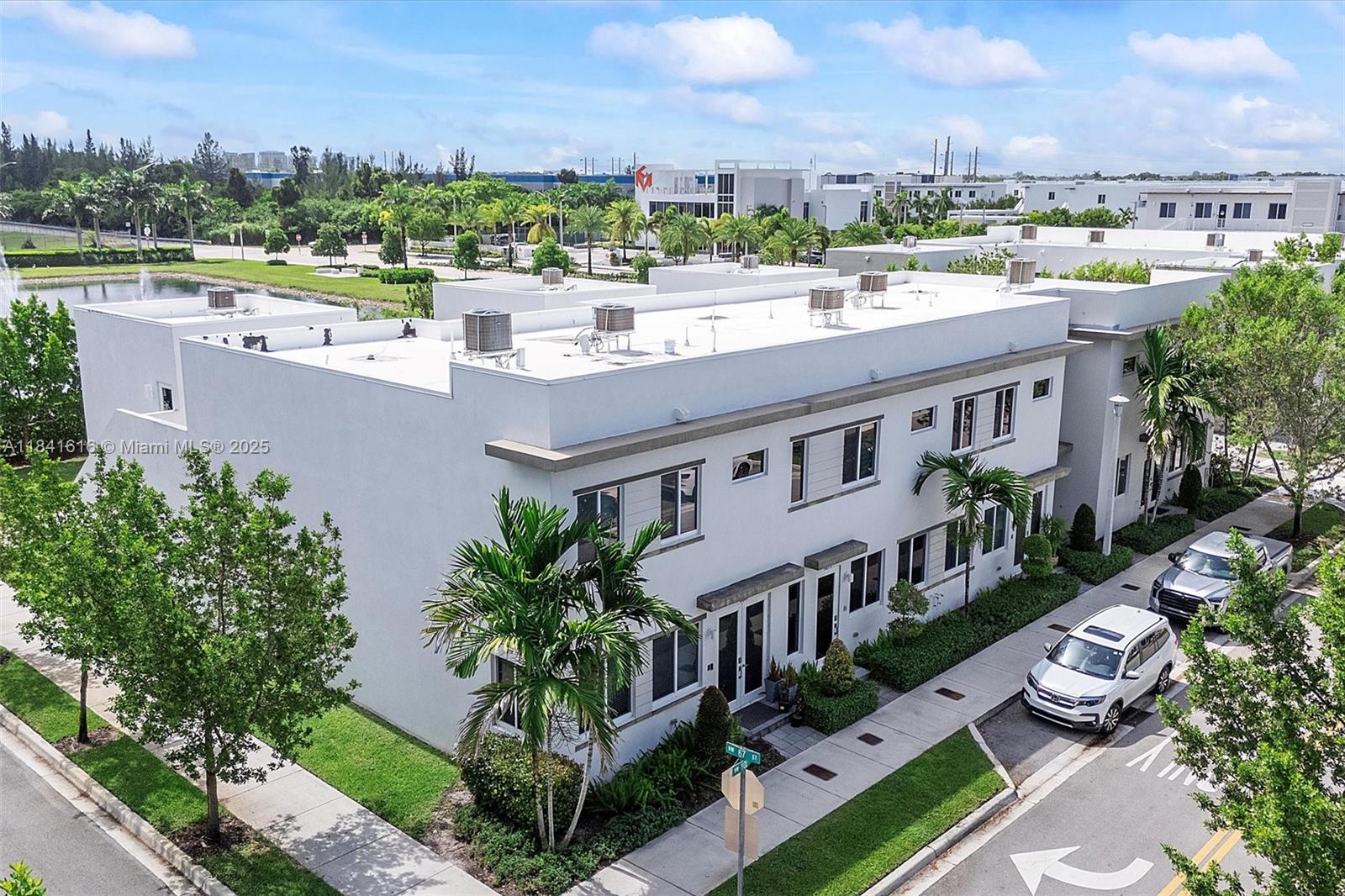 Enjoy lake views and modern comfort in this 3-bed, 2.5-bath townhouse in the desirable Landmark at Doral. Features include hardwood flooring, custom window and wall treatments, and energy-efficient design. The kitchen offers quartz counters, recessed lighting, and stylish finishes. A spacious living area opens to a back patio with low-maintenance turf and tranquil water views. Additional highlights include: 1-car garage, 2-car driveway, EV charging port, Vivint alarm system, and full smart home integration—smart lock, thermostat, ceiling fan, garage door opener, interior doors, security cameras, and network-ready for seamless connectivity. Close to the community clubhouse and gym. Move-in-ready with modern comforts in a peaceful setting—come see what makes it special.