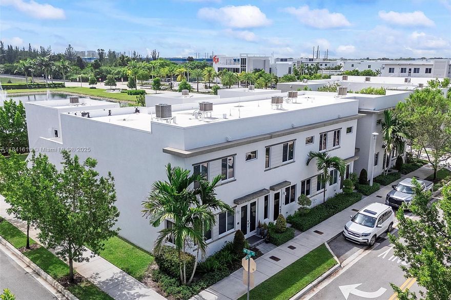 Enjoy lake views and modern comfort in this 3-bed, 2.5-bath townhouse in the desirable Landmark at Doral. Features include hardwood flooring, custom window and wall treatments, and energy-efficient design. The kitchen offers quartz counters, recessed lighting, and stylish finishes. A spacious living area opens to a back patio with low-maintenance turf and tranquil water views. Additional highlights include: 1-car covered garage, 3-car driveway, EV charging port, Vivint alarm system, and full smart home integration—smart lock, thermostat, ceiling fan, garage door opener, interior doors, security cameras, and network-ready for seamless connectivity. Close to the community clubhouse and gym. Move-in-ready with modern comforts in a peaceful setting—come see what makes it special.