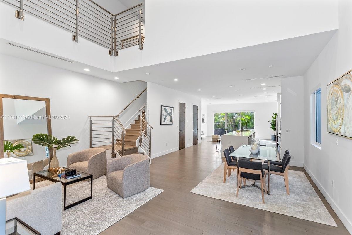 Welcome to this one-of-a-kind contemporary townhome, designed for luxurious living and effortless entertaining. Nestled in the vibrant heart of Coconut Grove, this two-story residence showcases an impressive entrance with soaring 20-foot ceilings and open-concept floor plan. The centerpiece of the home is the gourmet kitchen, featuring a waterfall-edge quartz island—ideal for dining and entertaining. The kitchen flows into the spacious living area, where floor-to-ceiling glass sliders open to the backyard with a pool. Upstairs, a beautifully main suite boasts a private balcony overlooking the pool, a spa-inspired ensuite, and a custom walk-in closet. Two additional bedrooms, each with its own full bath and built-in closets. just moments from Coconut Grove’s parks, top dining, shopping.