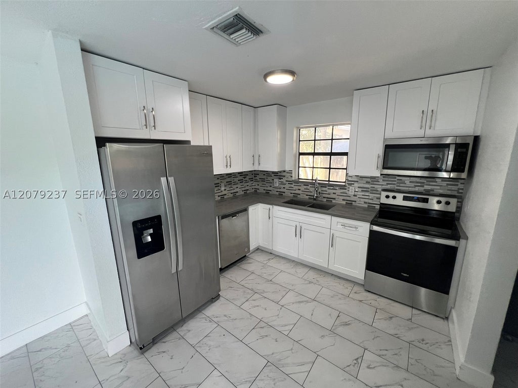Photo of 4421 NW 33rd St, Lauderdale Lakes, FL 33319 (MLS # A12079237)