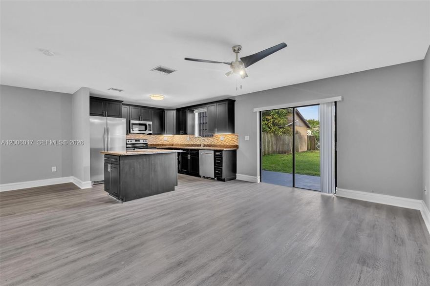 Completely renovated 3 Bedroom and 2.5 Bathroom two-story semi-detached home in the heart of North Miami, featuring a large private fenced backyard. Updated with granite countertops, solid wood shaker cabinets, stainless steel appliances.  tile and new modern waterproof vinyl flooring throughout. Spacious walk-in closet, dedicated laundry room with front-load washer/dryer, and a Newer Roof (2017). Move-in ready - schedule your showing today!