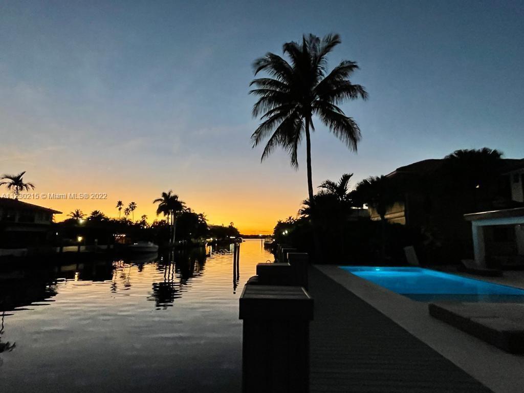 Brand New Construction Waterfront Home with 80 ft of dockage on oversized lot located at the private gated community of Eastern Shores. Boaters dream no fixed bridges & New Sea Wall. This luxurious masterpiece features many upgrades that were custom handcrafted, equipped w/ Sonos sound system, Tesla fast-charging station, and automated AC, lighting, & curtains controlled from app. Endless amounts of natural lighting in the huge high ceiling living area w/custom fireplace, stunning 16ft waterfall island Kitchen, and porcelanosa floors leading you upstairs to an oversized master suite offering bathtub and double shower & sinks, with private balcony to enjoy great sunset water views. Just minutes away from Sunny Isles Beach, Bal Harbour, Aventura Mall, and more shopping & dining.
