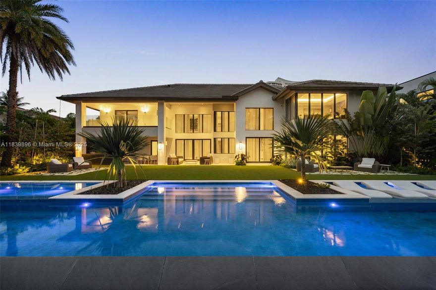 VILLA ENCANTO is a newly reimagined grand waterfront estate in prestigious Golden Isles, designed for those who value space, style, and seamless living. Redesigned by Pietra Casa Studio, this exquisite 6-bed, 7.5-bath residence blends elevated design with livable luxury, featuring premium European hand selected marble and millwork throughout. Thoughtfully curated interiors balance sophistication and comfort, creating an ideal setting for daily living and effortless entertaining. Indoor spaces open to a resort-style outdoor retreat with one of Florida's largest most beautifully designed infinity pools, spa, summer kitchen, lounge area, and 100-ft dock. Ideally located near top golf courses, exclusive clubs, fine dining, and international airports. Furniture available at additional cost.